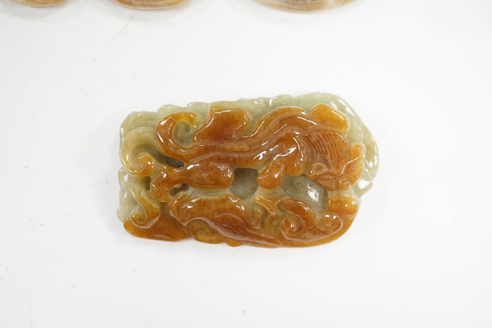 Four Chinese jadeite and hardstone carvings including dragons, largest 16cm in length. Condition - good